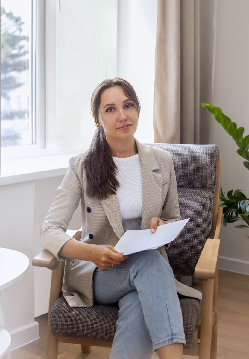 attractive businesswoman sitting chair with papers office